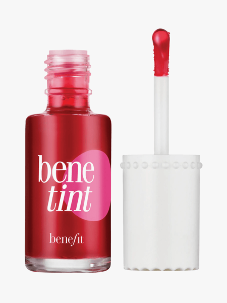 Benefit Benetint Cheek & Lip Stain in branded clear bottle with white brush applicator on light gray background