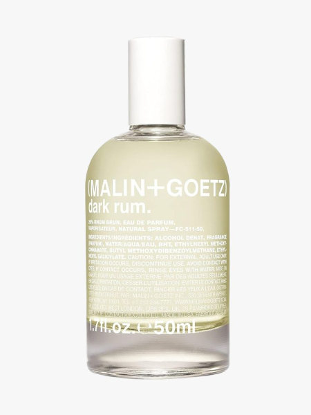 Malin + Goetz Dark Rum Eau de Parfum bottle of pale yellow perfume with white cap on light gray background