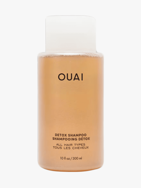 Ouai Detox Shampoo in clear bottle component with black accents on a light gray background