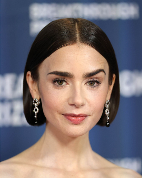 Lily Collins with a short straight bob on a middle part.