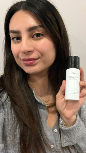 Allure commerce writer Jennifer Hussein holding the Byredo Mojave Ghost Hair Perfume