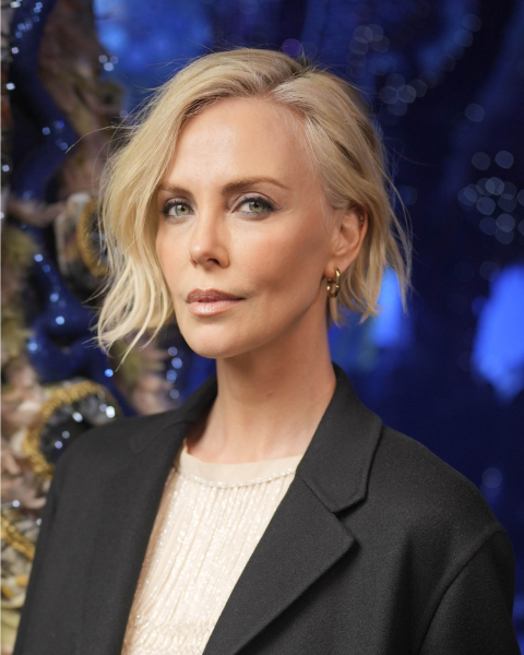 Charlize Theron with a blonde aline wavy bob.