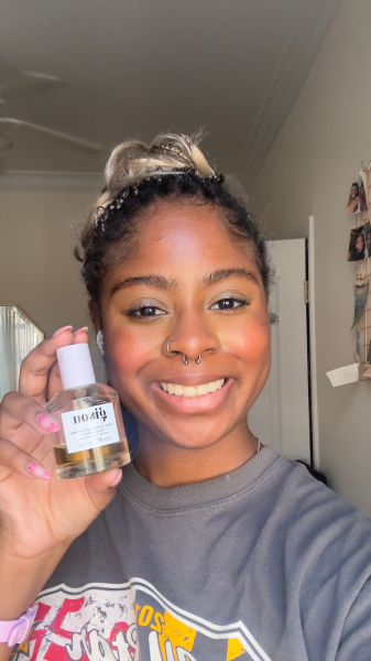 Image may contain Face Head Person Photography Portrait Bottle Cosmetics Perfume Happy Smile Selfie and Clothing