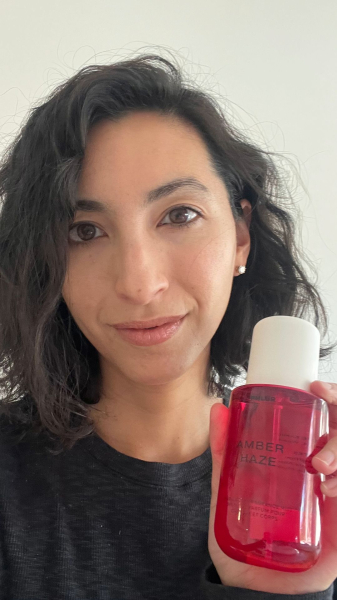 Allure contributing editor Deanna Pai holding the Phlur Amber Haze Hair  Body Fragrance Mist